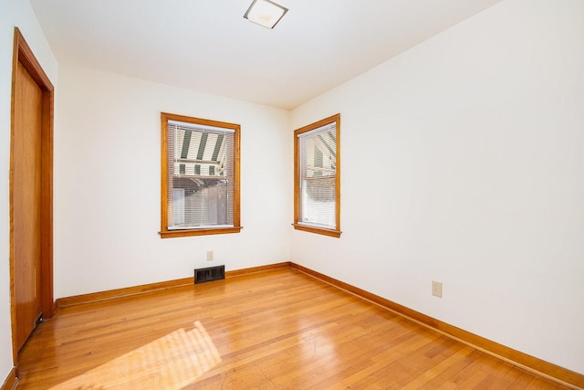 spare room with light hardwood / wood-style flooring