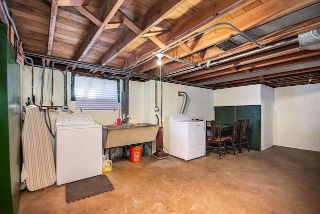 basement with washer and clothes dryer and sink