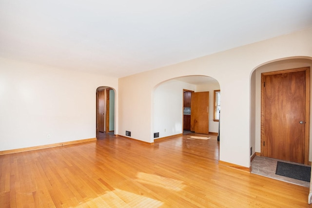 spare room with wood-type flooring