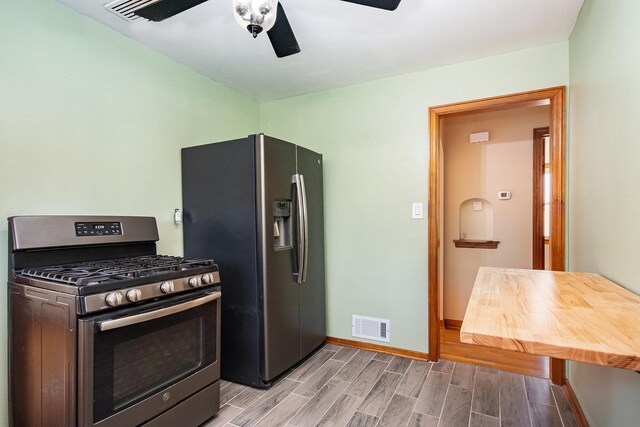 kitchen featuring ceiling fan, light hardwood / wood-style floors, and appliances with stainless steel finishes