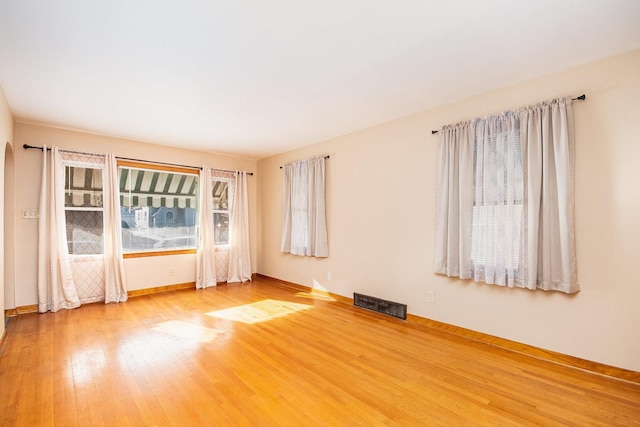 empty room with hardwood / wood-style floors