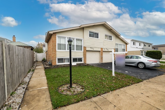 view of front of home featuring a garage and a front lawn