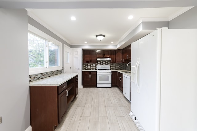 kitchen featuring tasteful backsplash, ornamental molding, white appliances, dark brown cabinetry, and sink