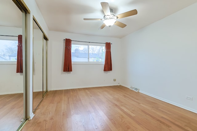 unfurnished bedroom with ceiling fan and light hardwood / wood-style flooring