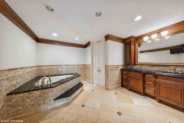 bathroom with tile patterned floors, vanity, crown molding, and a tub