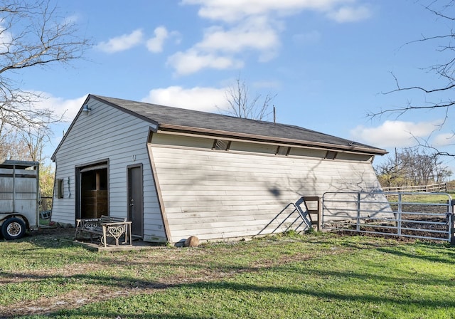 view of outbuilding with a yard