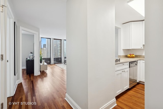 hall with hardwood / wood-style flooring and floor to ceiling windows