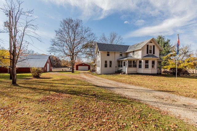 exterior space with an outbuilding, a yard, and a garage