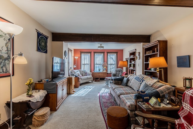 living room featuring beamed ceiling and light colored carpet