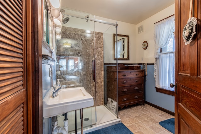 bathroom with tile patterned floors and an enclosed shower