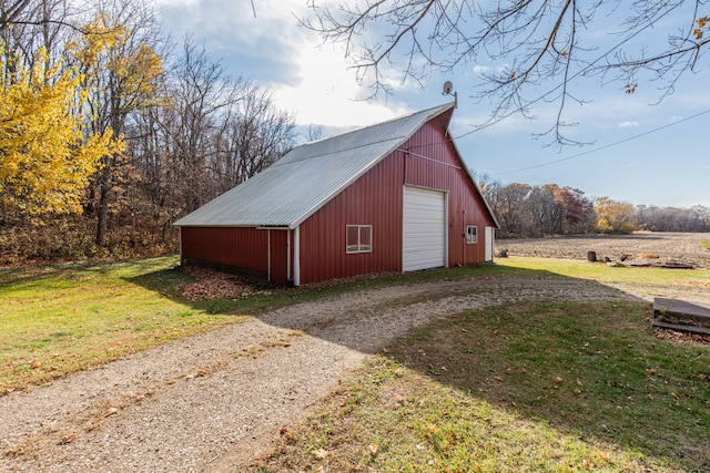 view of outbuilding featuring a garage and a lawn