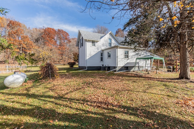 view of side of home with a yard