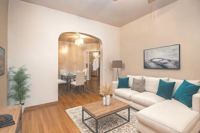 living room featuring light wood-type flooring and an inviting chandelier