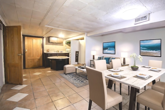 dining area with light tile patterned floors and sink