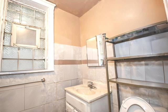 bathroom with vanity and tile walls