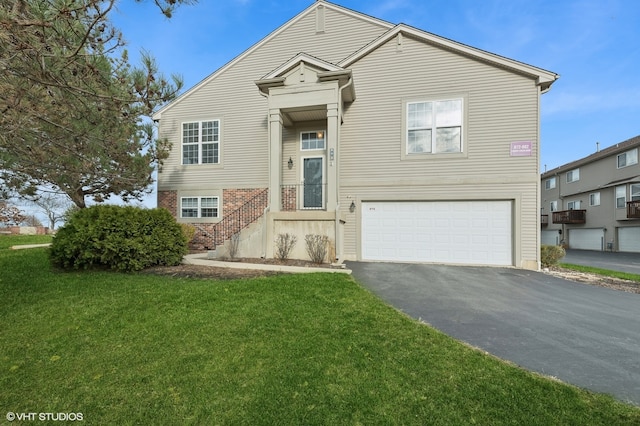 view of front of home with a front yard and a garage