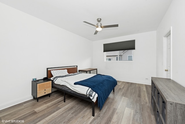 bedroom with wood-type flooring and ceiling fan