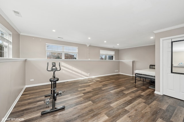 exercise area with plenty of natural light, dark hardwood / wood-style flooring, and ornamental molding