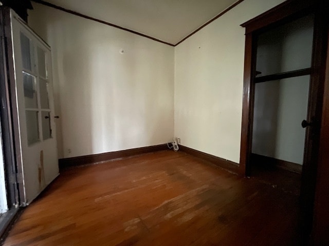 unfurnished bedroom featuring dark hardwood / wood-style flooring