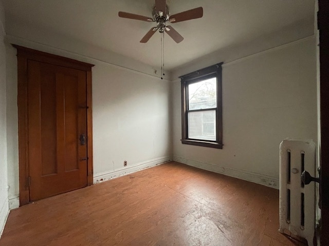 spare room with ceiling fan and light wood-type flooring