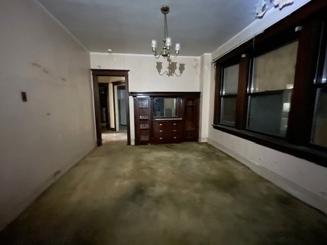 unfurnished dining area with a notable chandelier