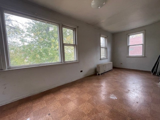 unfurnished room featuring radiator