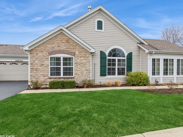 view of front of property featuring a garage and a front yard