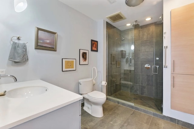 bathroom with an enclosed shower, vanity, toilet, and tile patterned floors