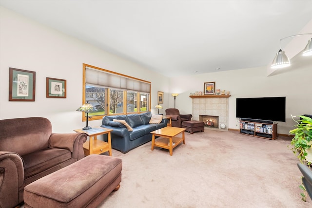 living room featuring carpet and a tiled fireplace