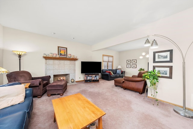 living room featuring carpet flooring and a tile fireplace