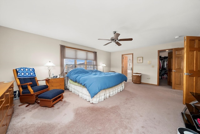 bedroom featuring connected bathroom, ceiling fan, a spacious closet, carpet floors, and a closet