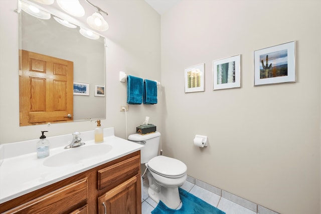 bathroom with tile patterned flooring, vanity, and toilet