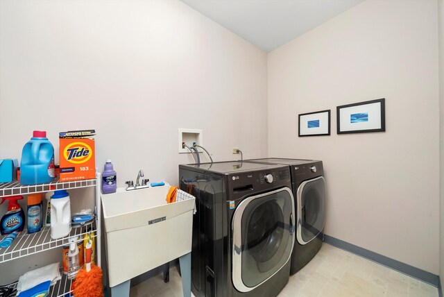 washroom with separate washer and dryer and sink