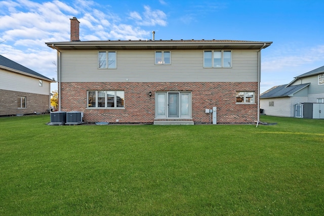 back of property with a lawn and central air condition unit