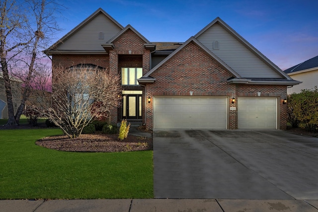 front facade with a yard and a garage