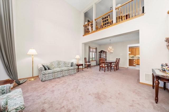 carpeted living room with a notable chandelier and a high ceiling