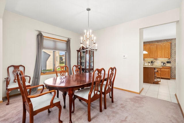 carpeted dining area with a chandelier