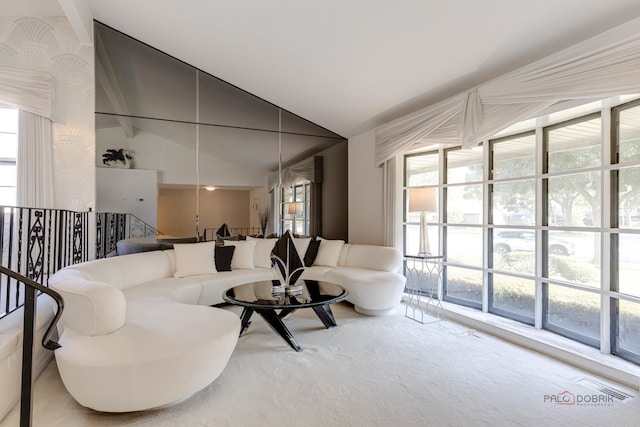 living room with carpet floors, high vaulted ceiling, and a wealth of natural light