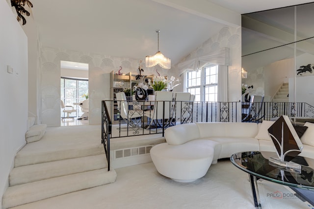 carpeted living room with vaulted ceiling with beams, plenty of natural light, and a chandelier