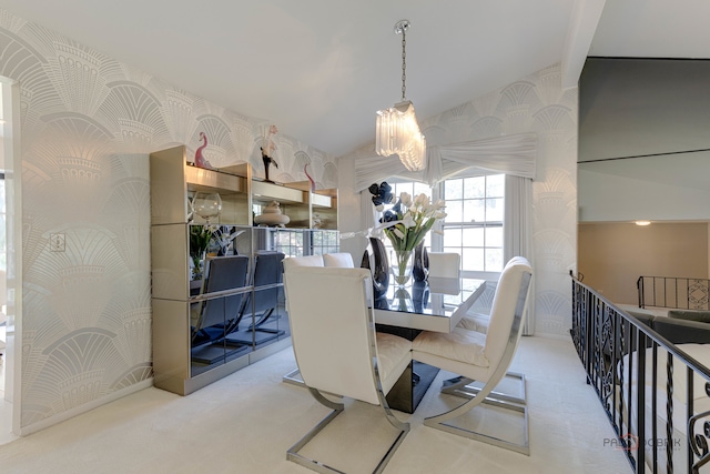 dining space featuring light colored carpet, lofted ceiling, and an inviting chandelier