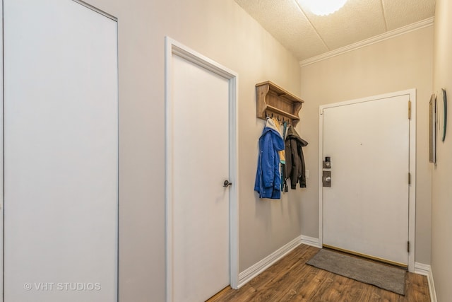 doorway featuring a textured ceiling, hardwood / wood-style flooring, and crown molding