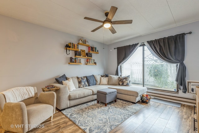 living room with wood-type flooring and ceiling fan