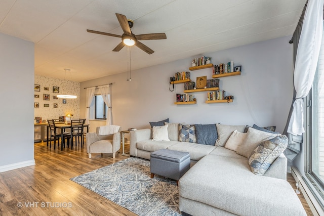 living room featuring ceiling fan and hardwood / wood-style flooring