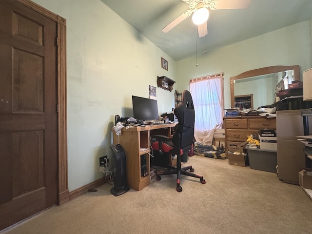 carpeted home office featuring ceiling fan and vaulted ceiling