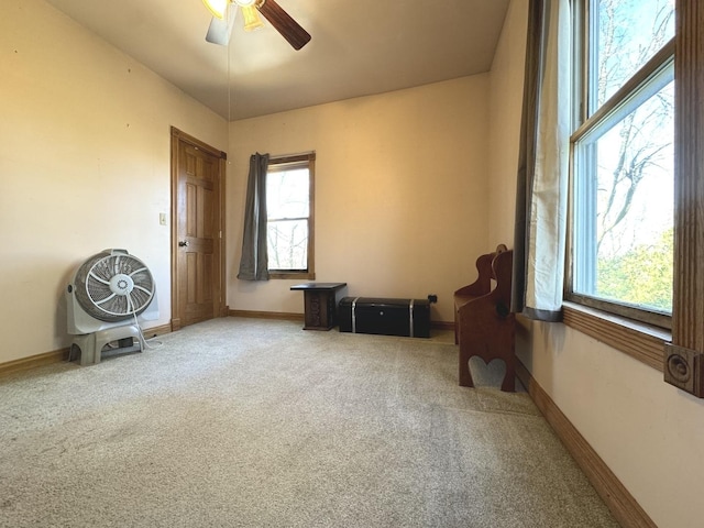 carpeted empty room featuring ceiling fan