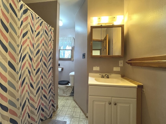 bathroom featuring vanity and toilet