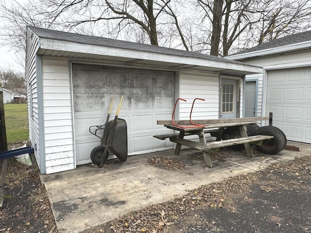 exterior space with a garage and an outdoor structure