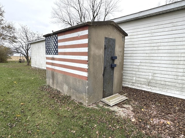 view of outbuilding featuring a yard