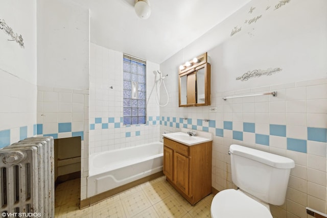 full bathroom featuring toilet, tile walls, radiator, and shower / washtub combination