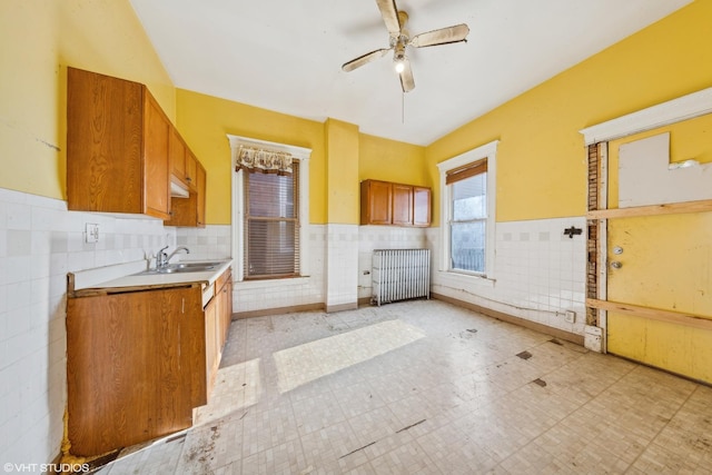 bathroom with radiator heating unit, wainscoting, tile patterned floors, vanity, and a ceiling fan